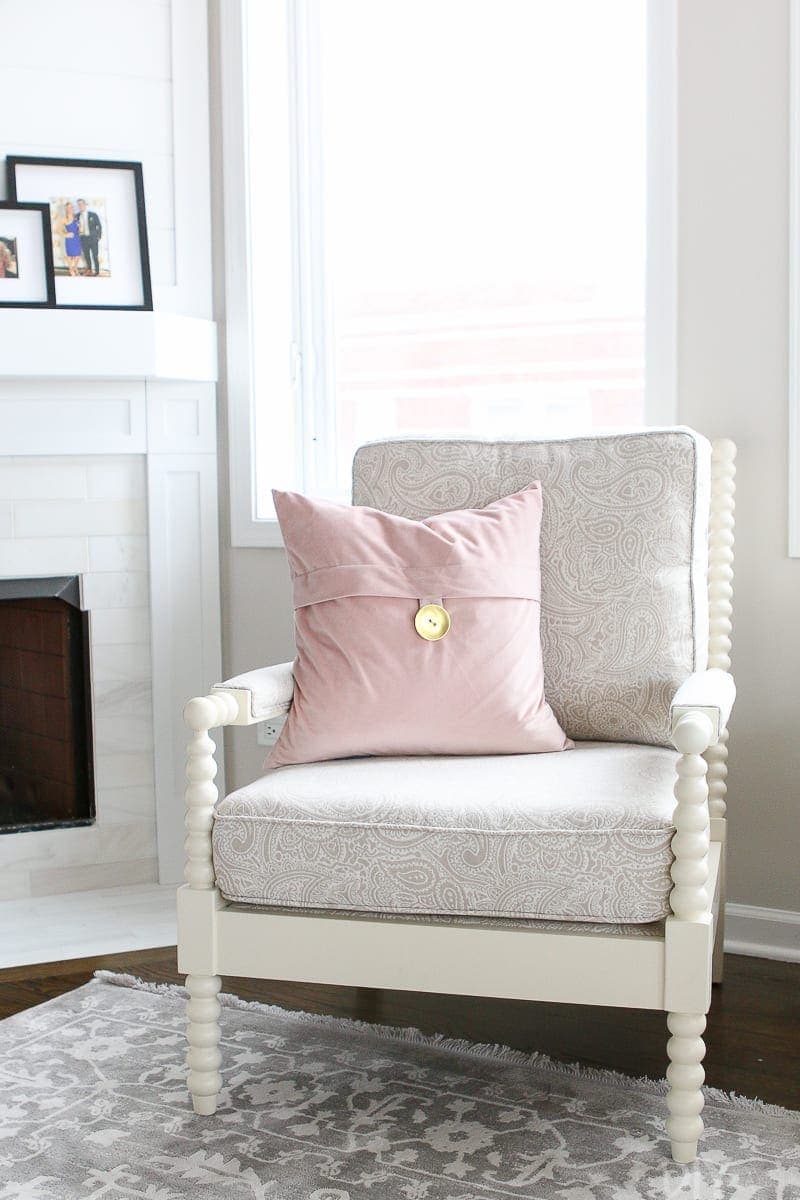 A white club chair that is comfortable and sleek