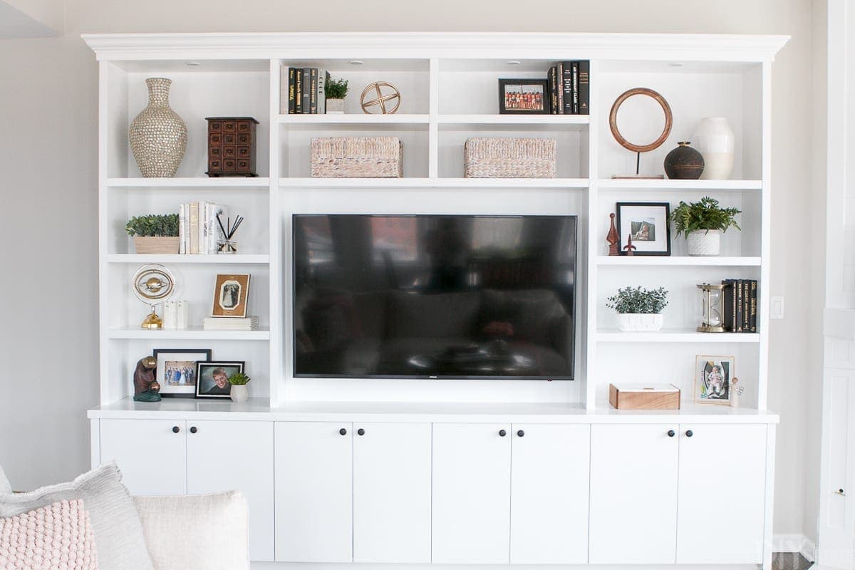 Floor to ceiling white built-in entertainment center