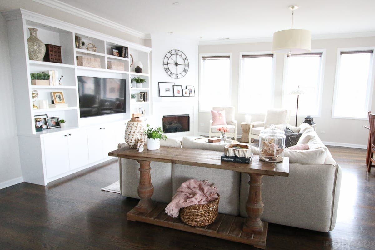 Open concept family room with white built-ins and large sectional