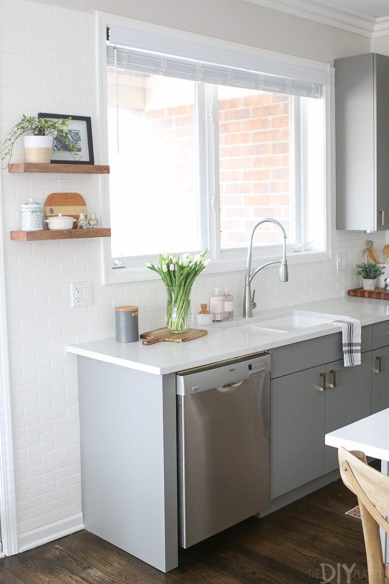 White countertops and gray cabinets. 