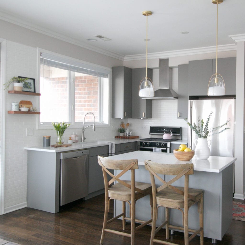 A gray kitchen with marble countertops