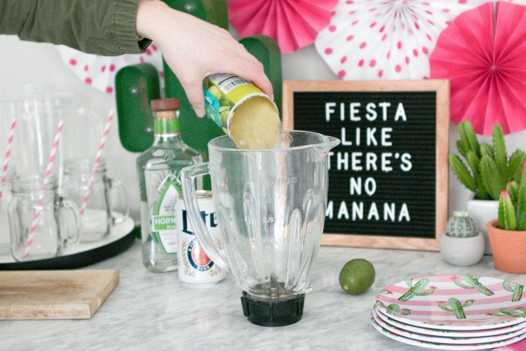 pouring limeade into a margarita