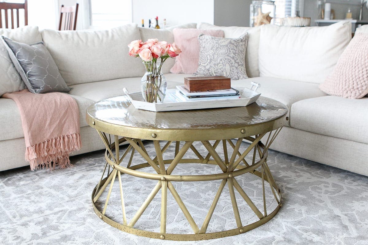 Love this round and gold coffee table with a large sectional