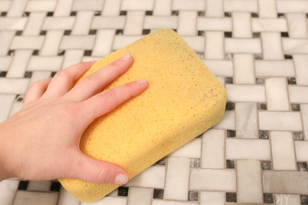 Use a sponge to wipe up grout