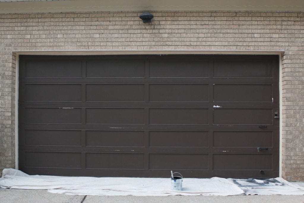 the process of painting our old garage door black