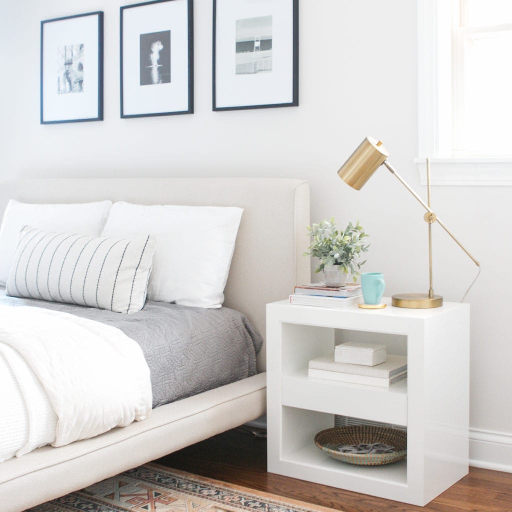 white nightstands with brass table lamp