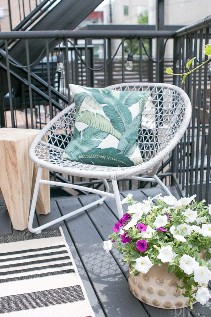 Palm print pillow on this gray outdoor lounger