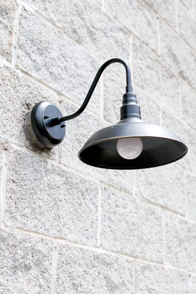 A farmhouse light fixture updates the exterior of this home