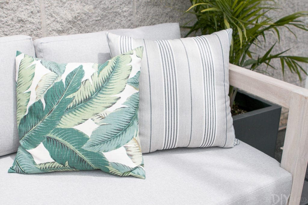 Outdoor pillows with palm print and stripes