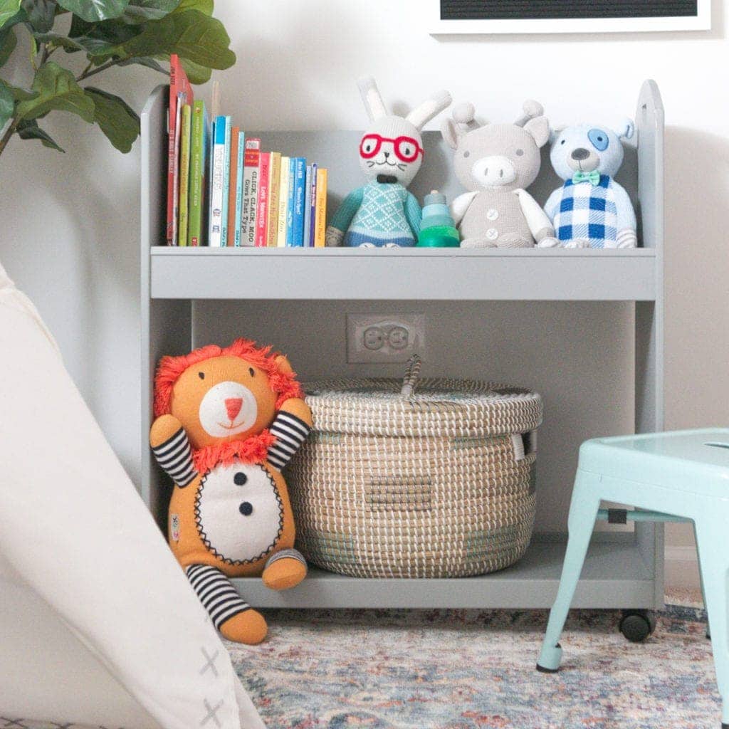 Put a small basket on the bottom of a bookshelf for hidden storage