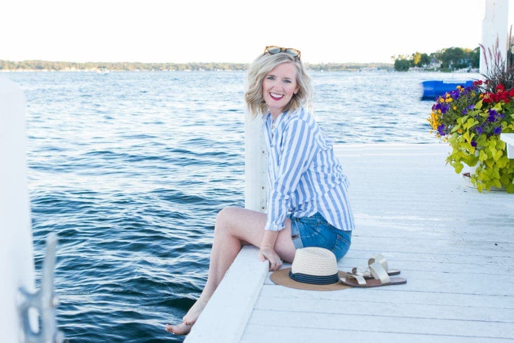 Bridget sitting on a pier during summertime