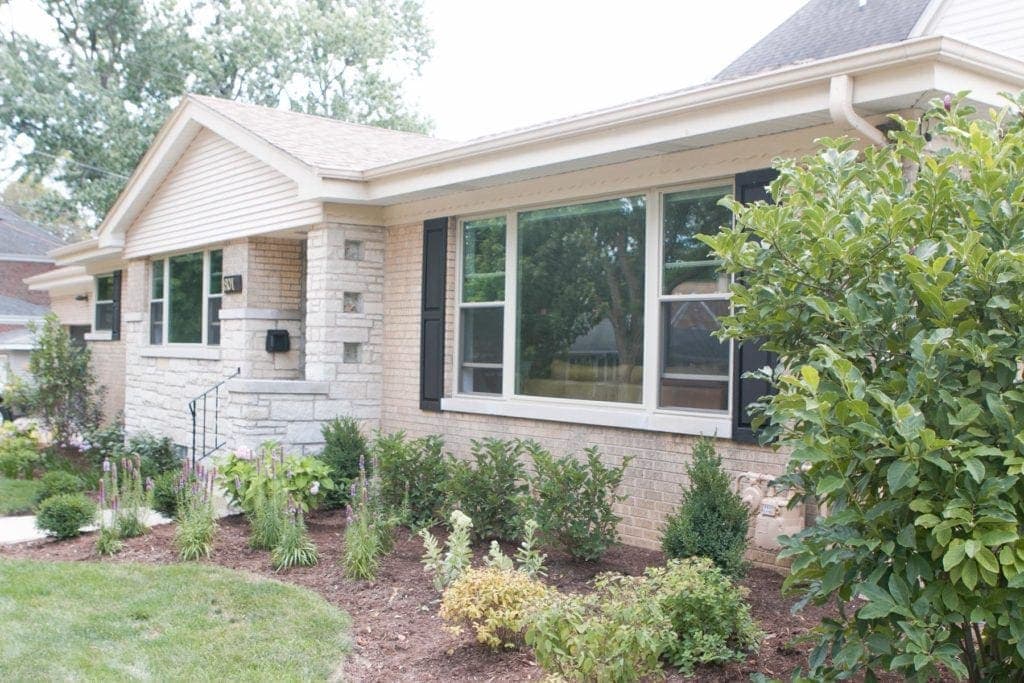 new landscaping and black shutters