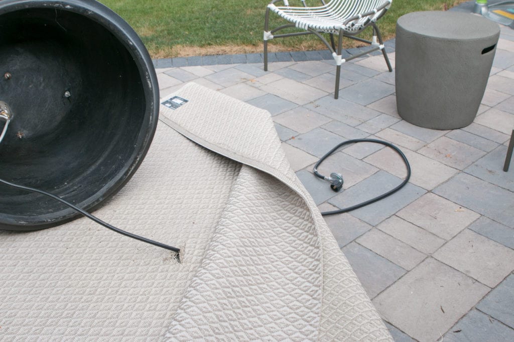 hiding a propane tank on a patio with an outdoor rug