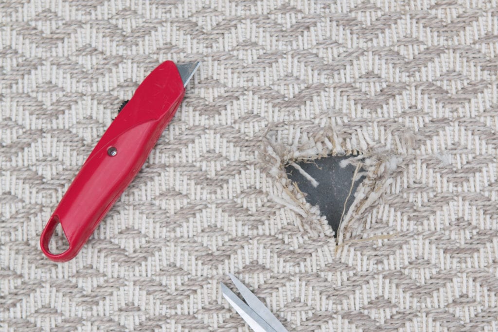 Cutting an outdoor rug to hide a propane tank