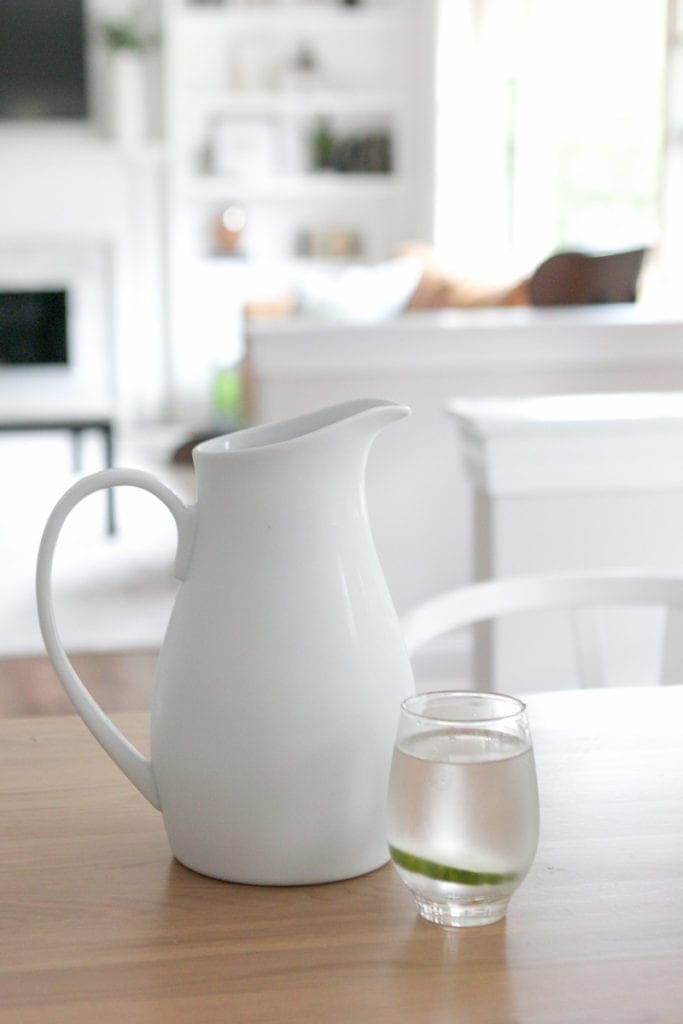 filling a glass pitcher with water