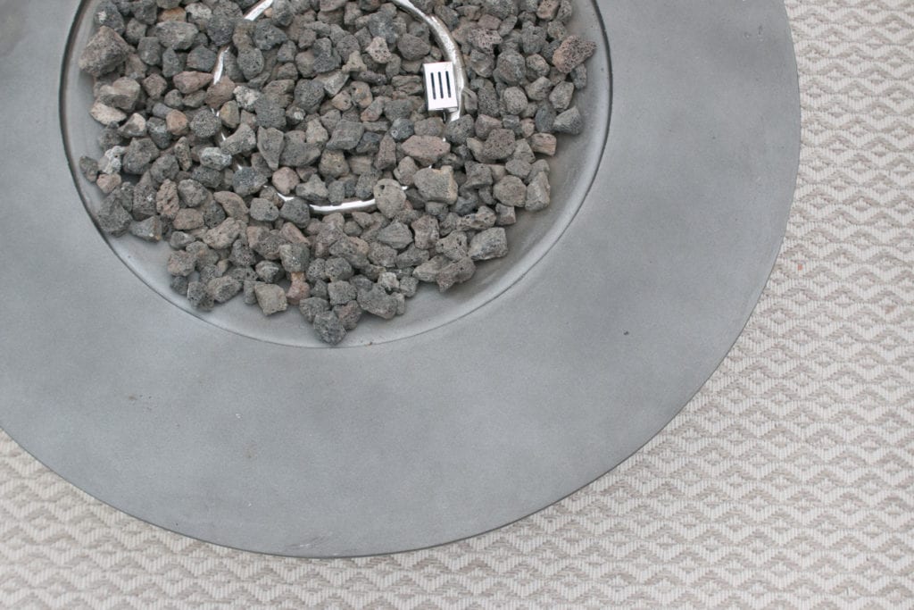 a sleek modern fire pit and propane tank
