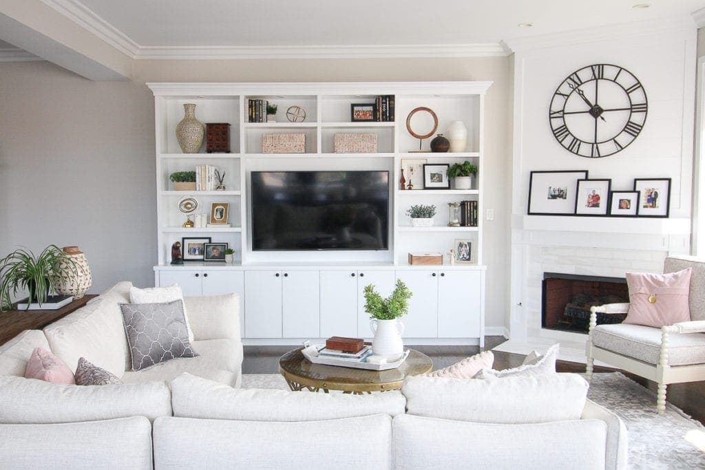 White built-ins in a family room with accessories