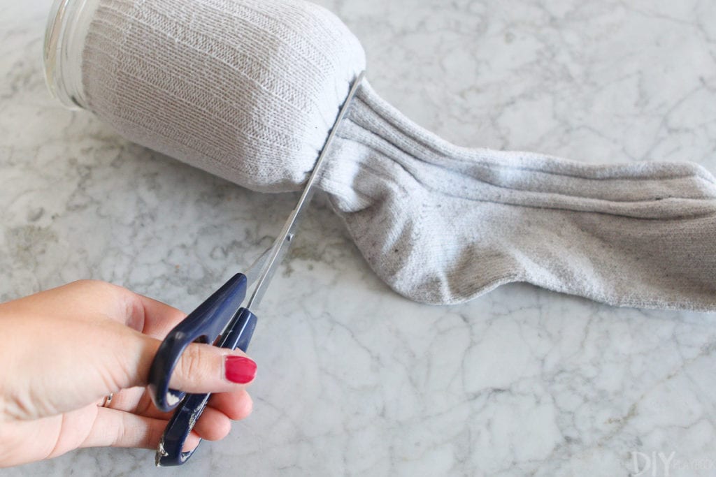 Cutting the foot of the sock off 