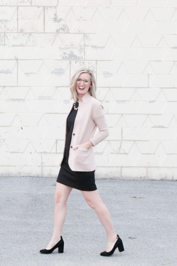 Walking to work in a black dress and blazer