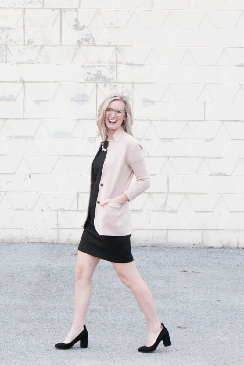 Walking to work in a black dress and blazer