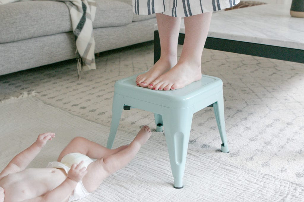 standing above baby for better baby photos