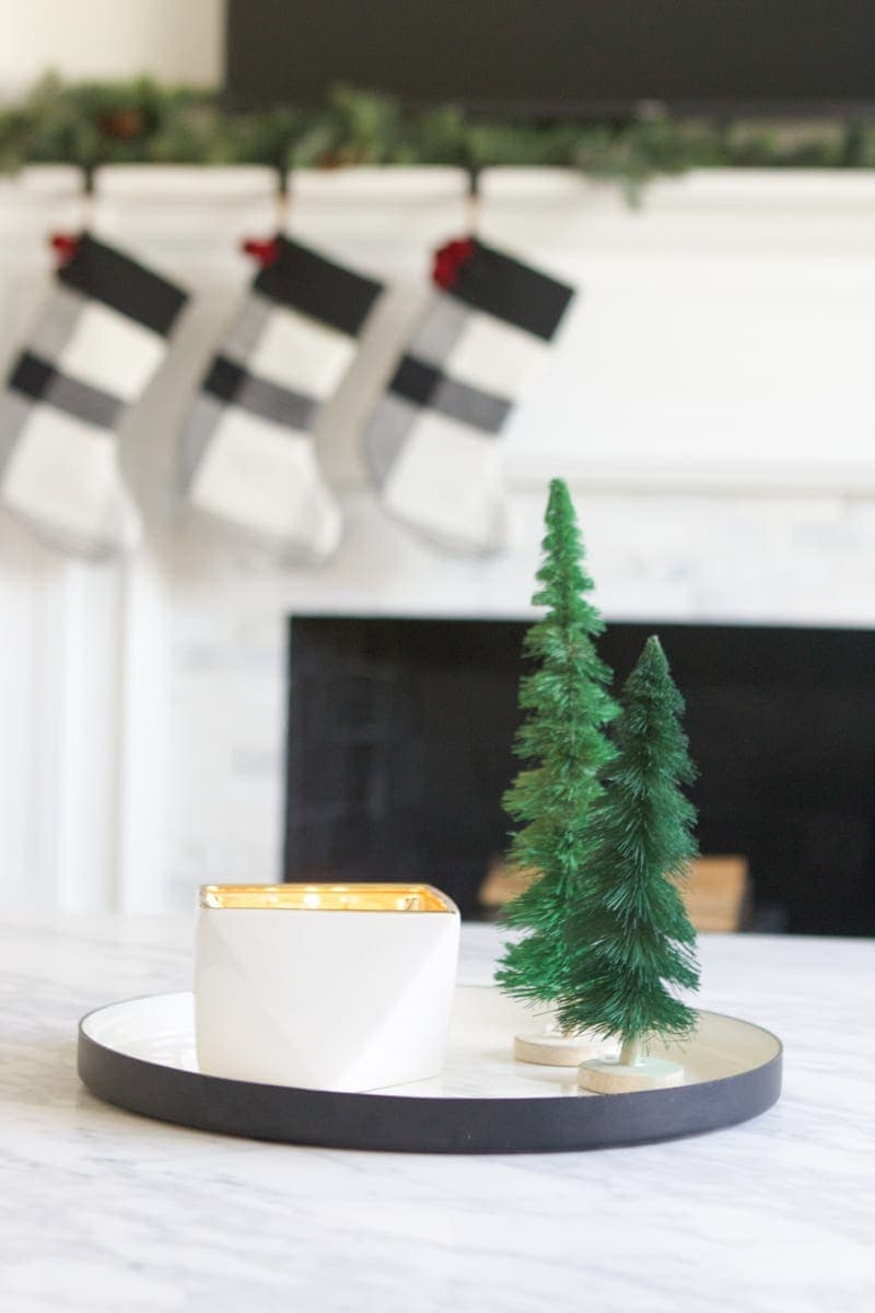 candle and christmas trees on a tray