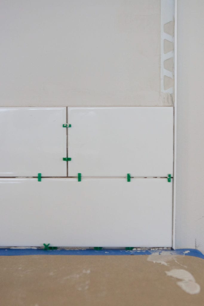 hanging backsplash tile next to schluter