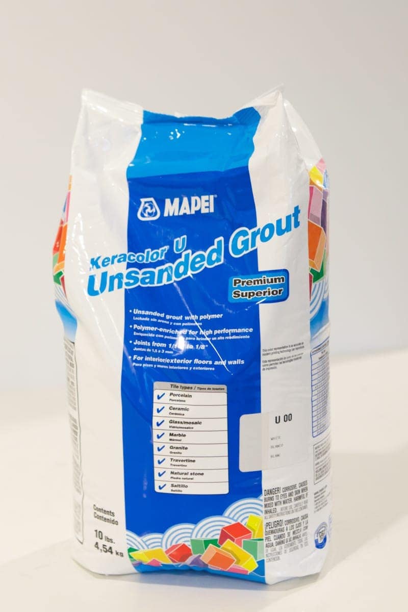 using the directions on the grout to mix