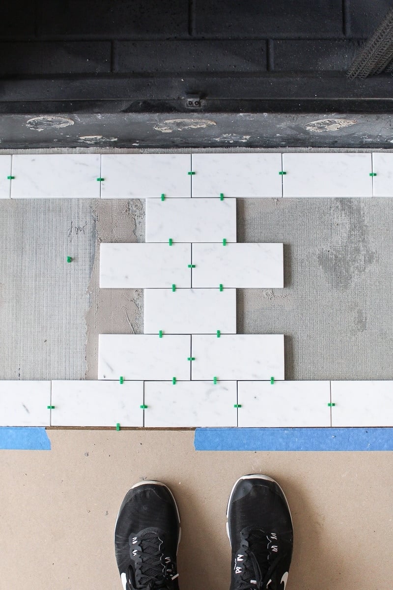 Laying out marble subway tile to prep