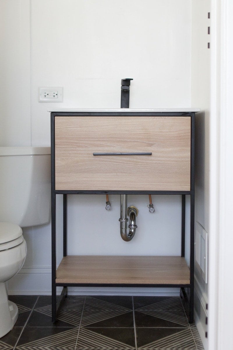 open vanity with exposed pipes