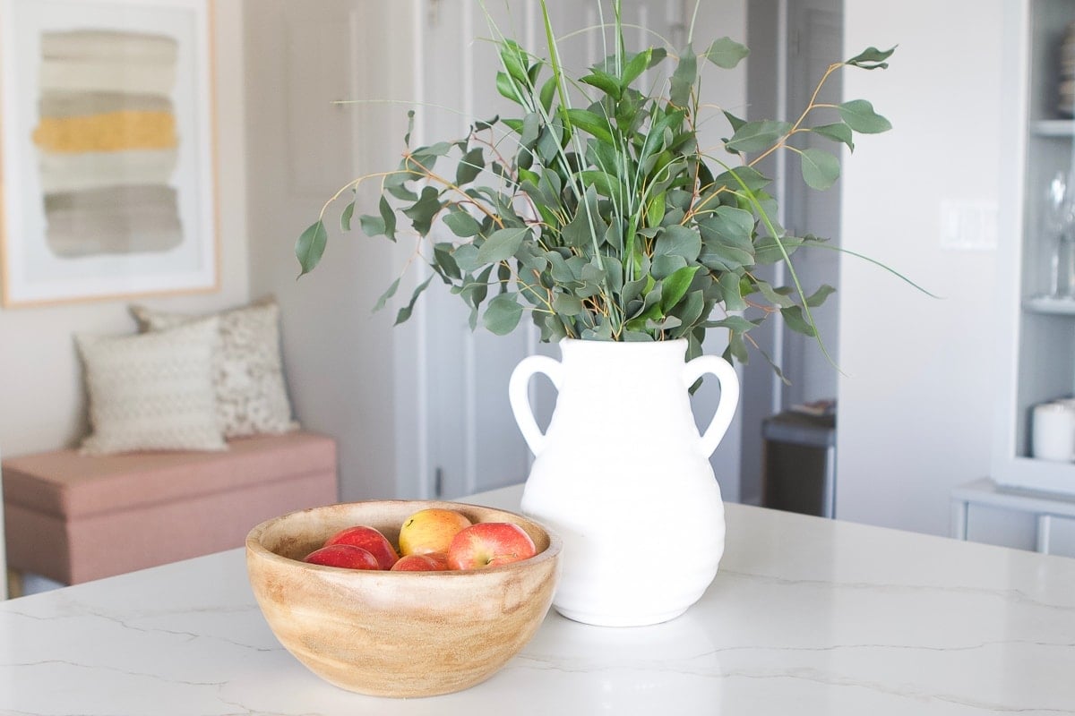 Fruit bowl and fresh eucalyptus on a kitchen counter
