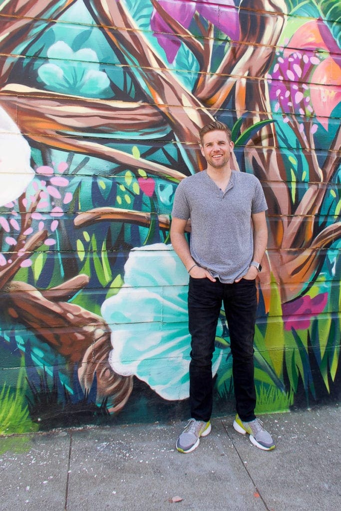 finn in front of a wall mural