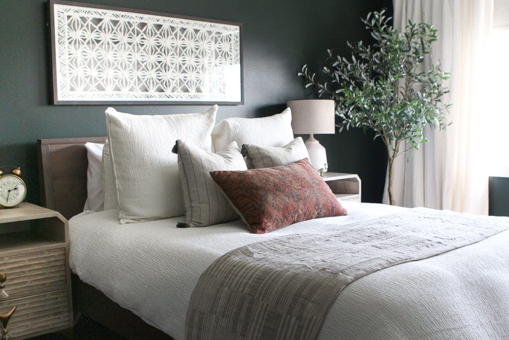 Dark green guest room with white bedding