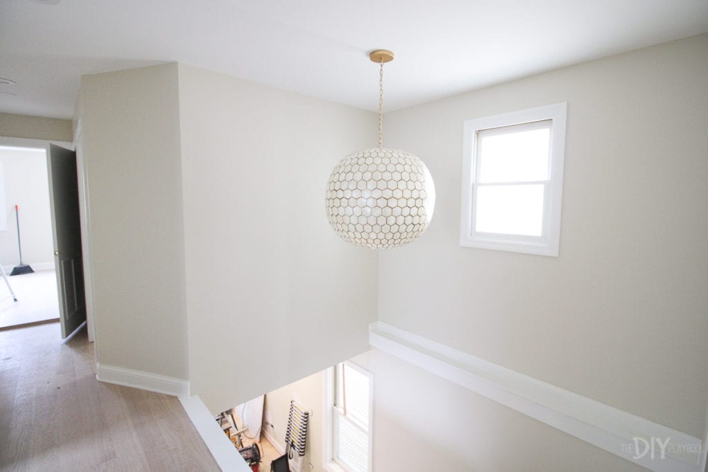 Stairwell and hallway with light fixture from serena and lily