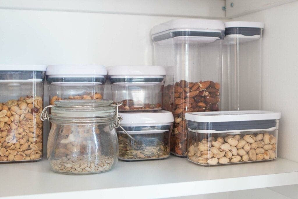 Placing nuts in clear canisters