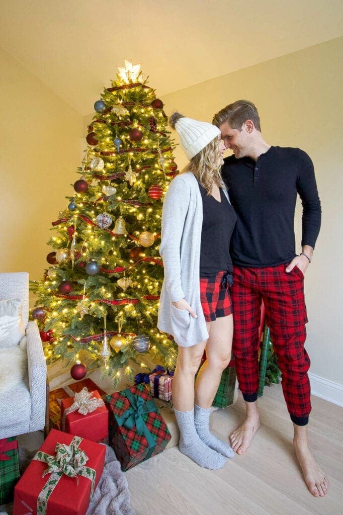 Casey and Finn in front of a tree for Christmas