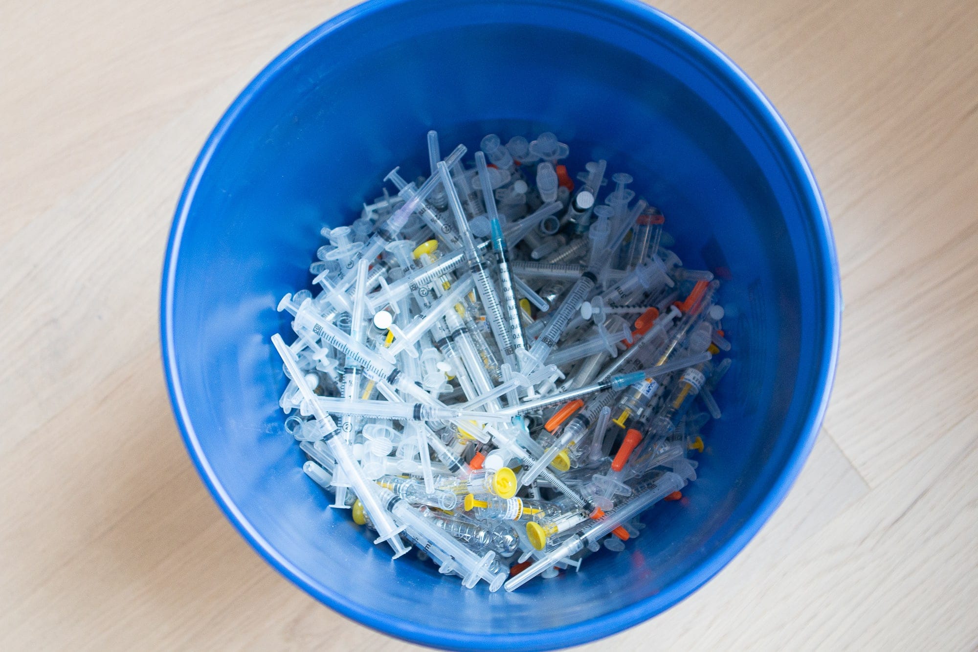 5-gallon bucket filled with used needles
