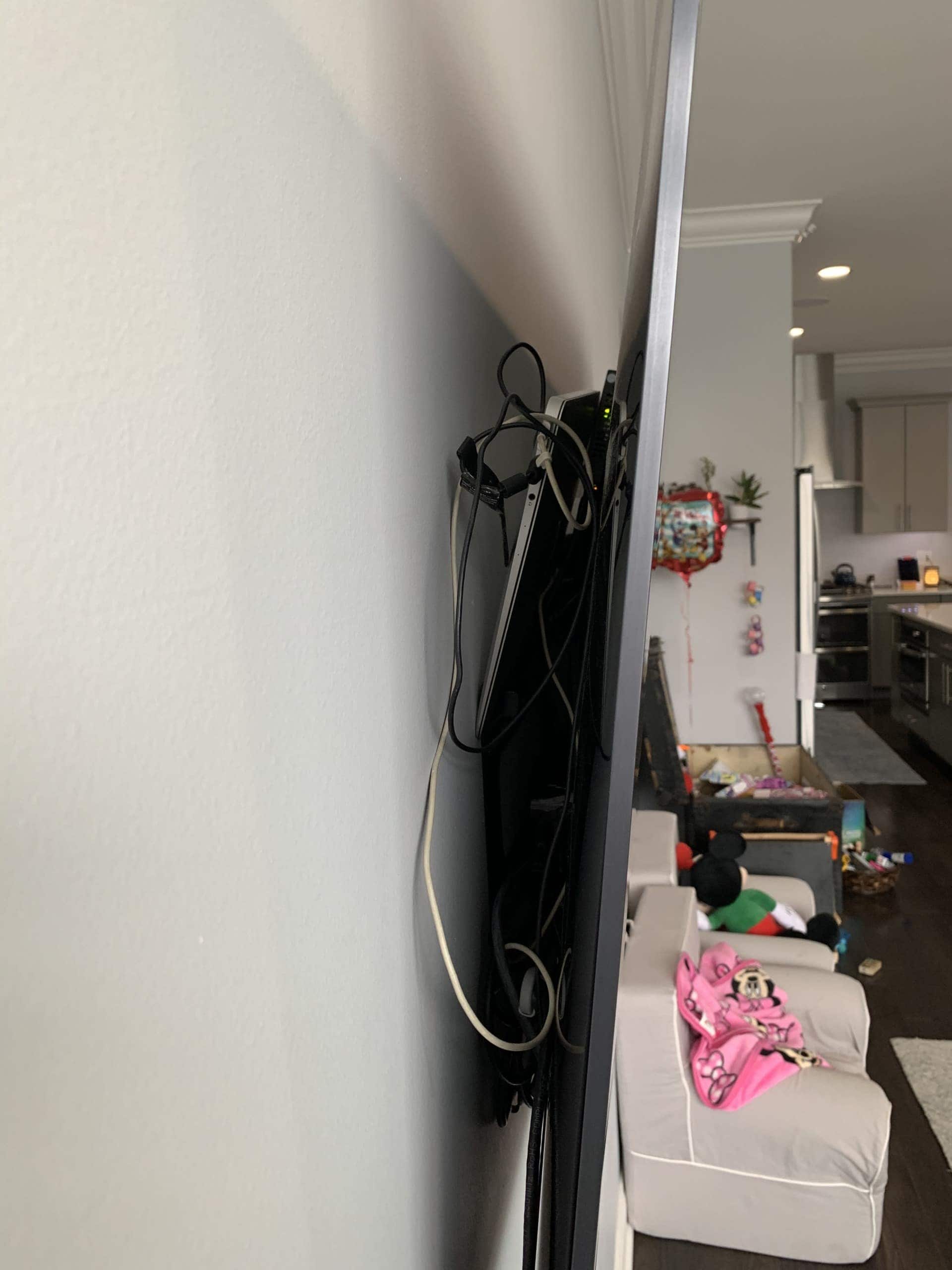 Laptop thrown behind the TV