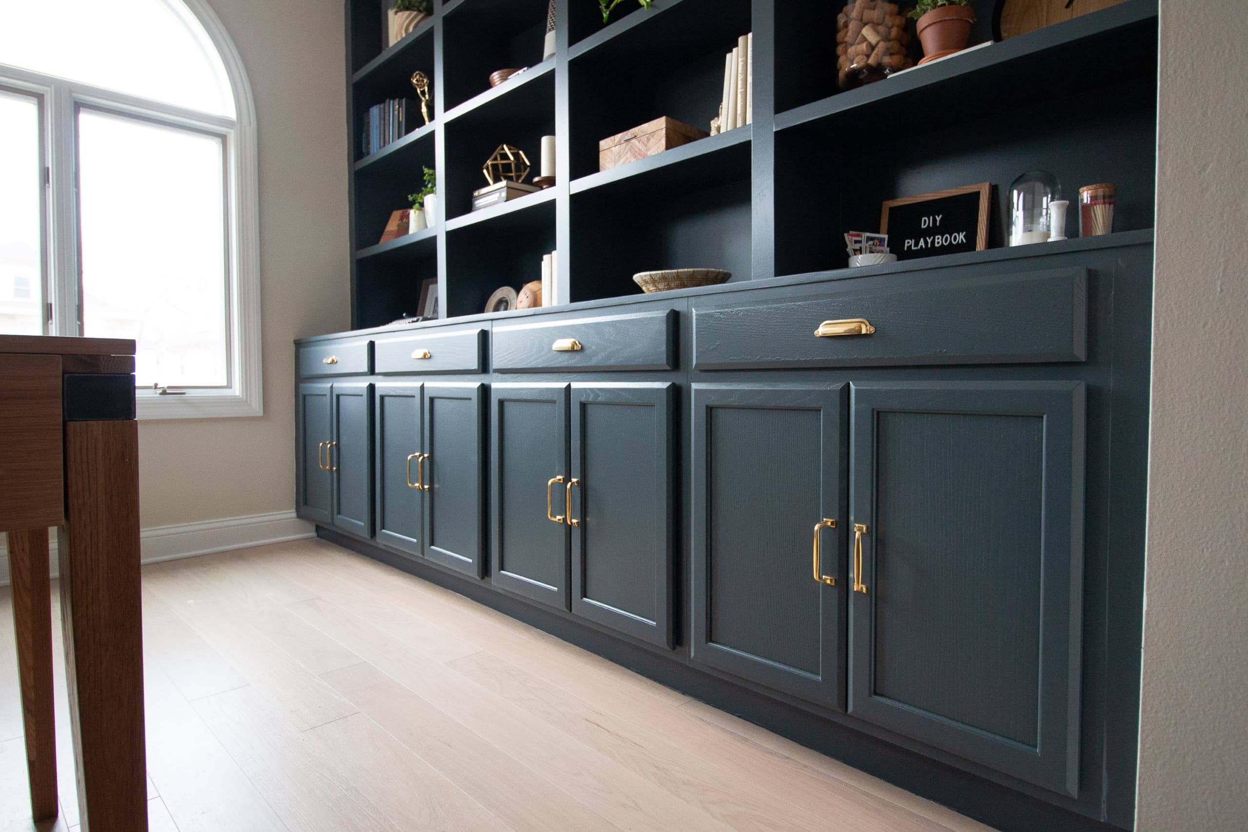 Brass hardware on navy bookcases
