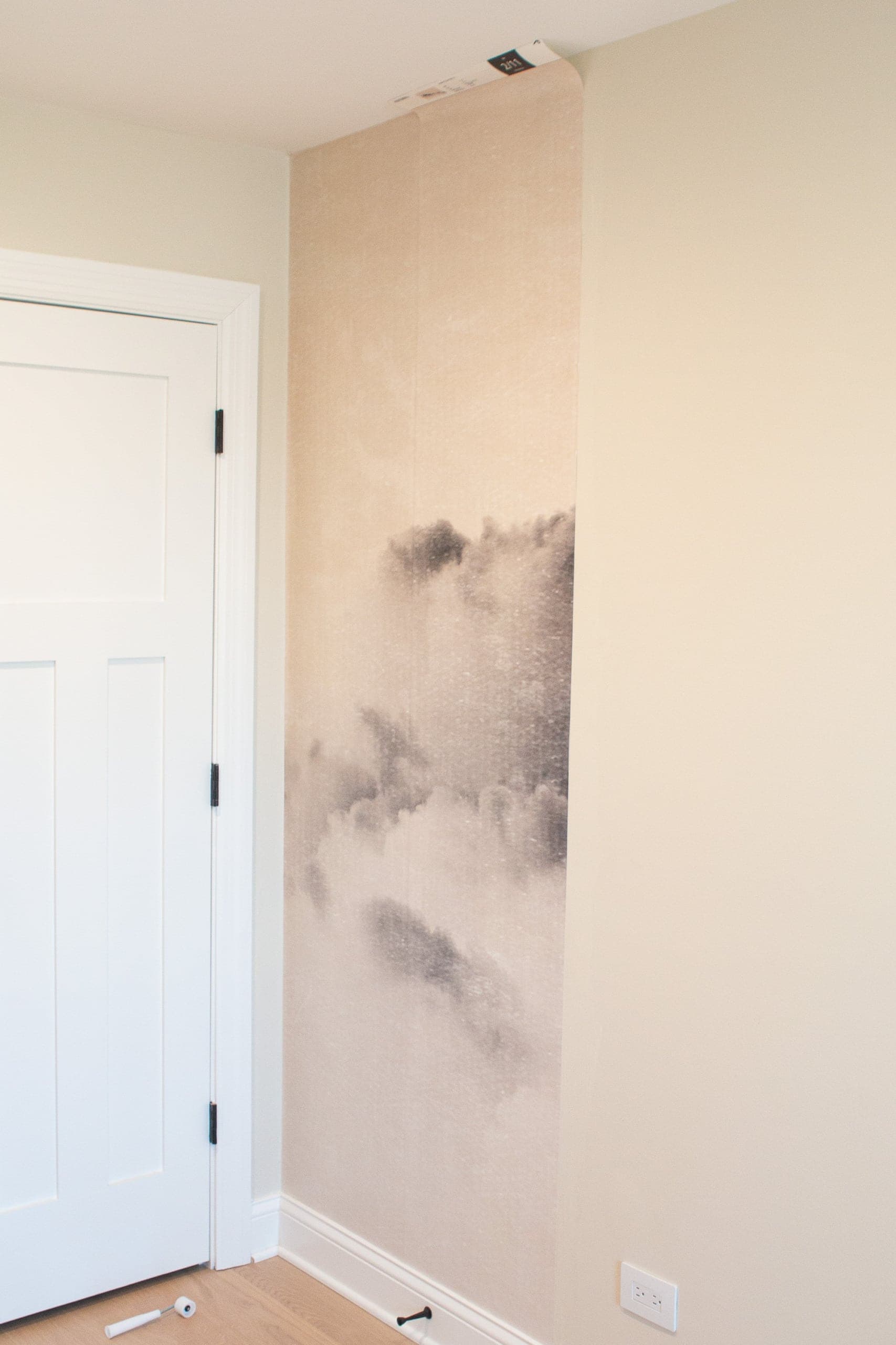 Applying the second strip of wallpaper