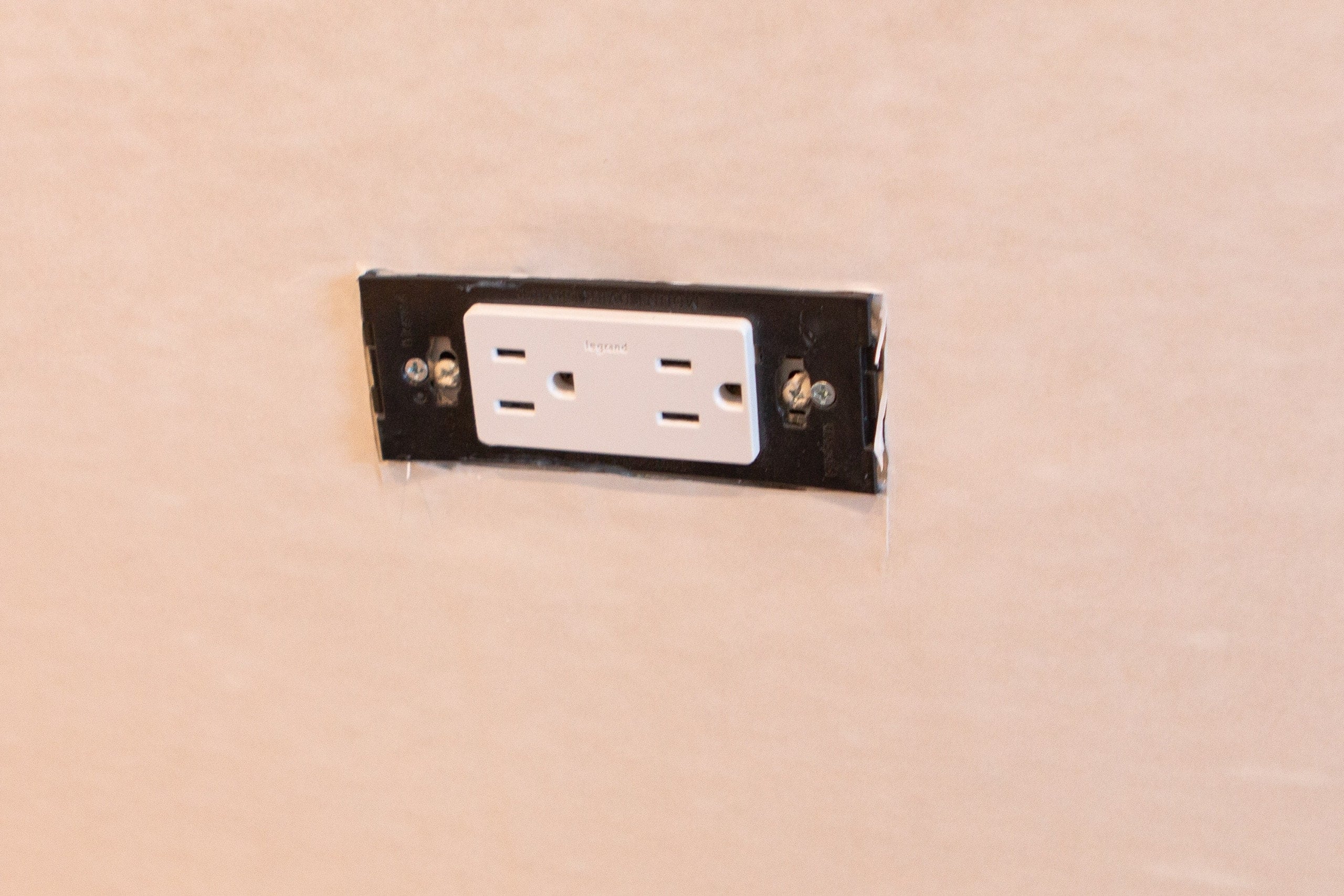 Cutting wallpaper around an outlet