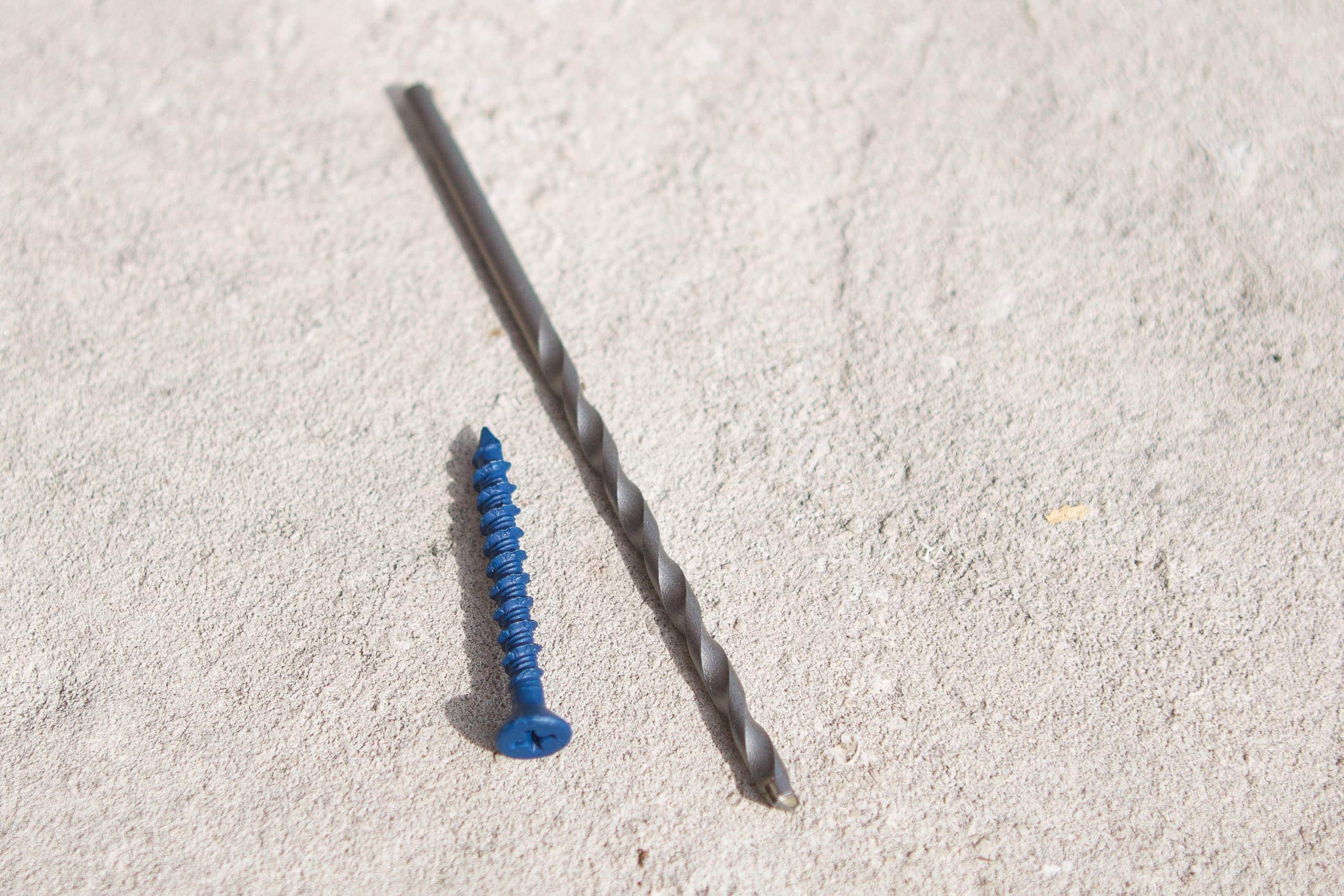 Drill bit and concrets screws to install a flag pole into brick