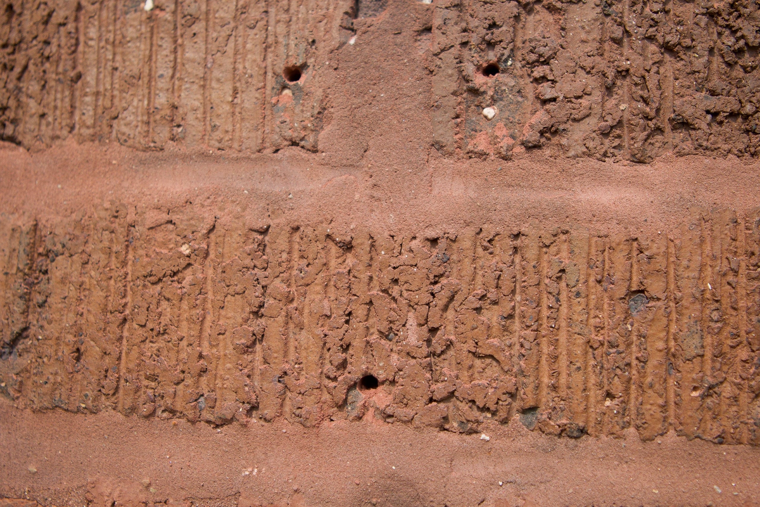 Use a hammer drill to make holes in your brick