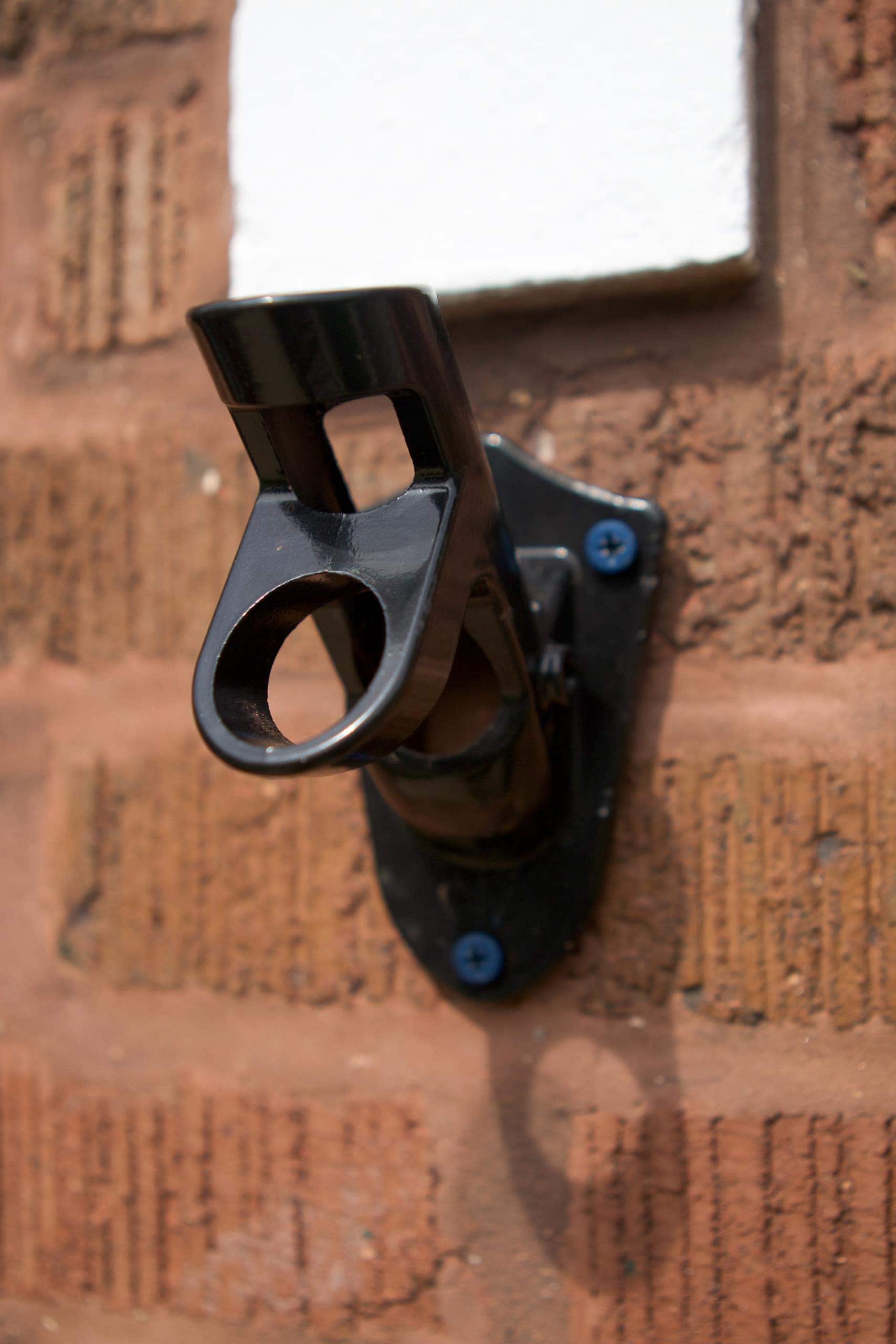 Screw the bracket into brick