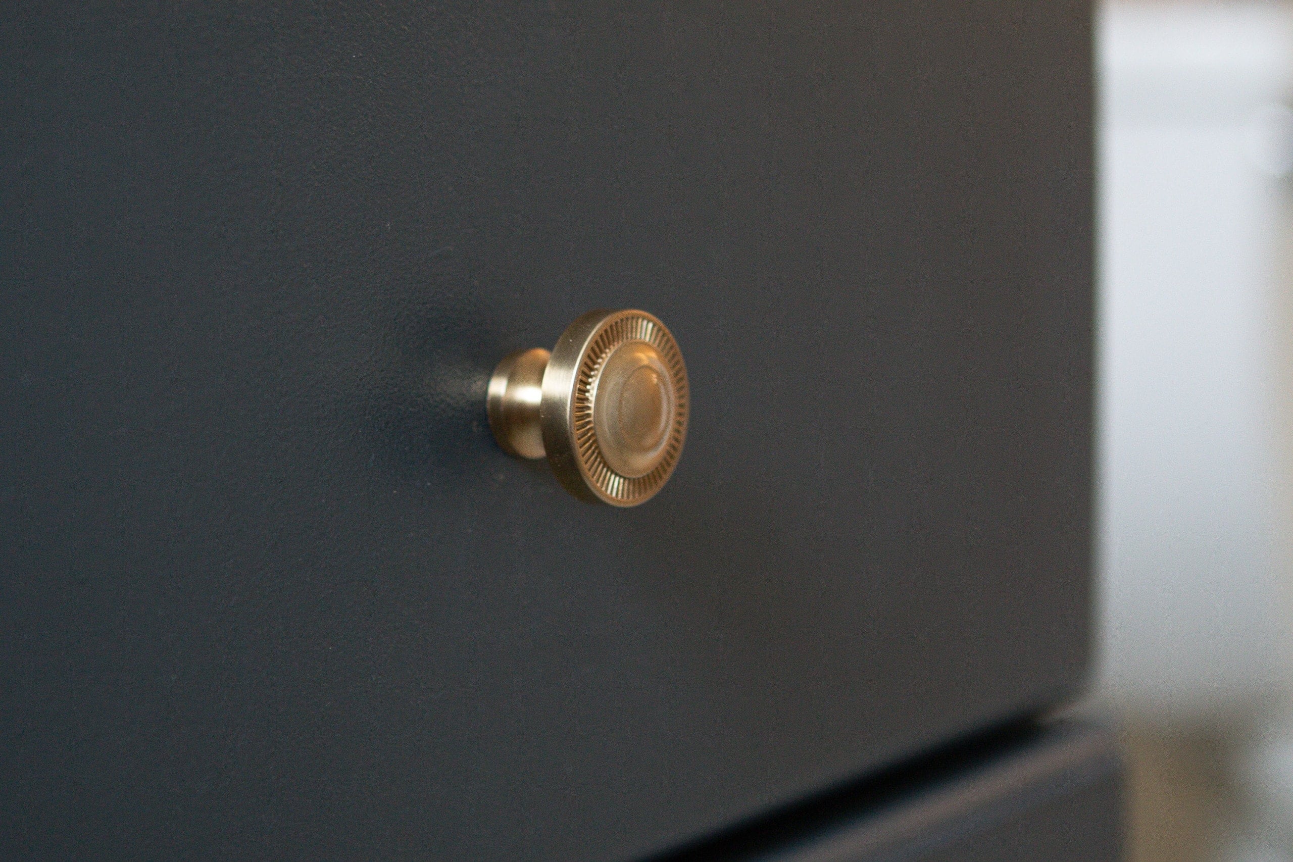 Gold hardware on navy cabinets