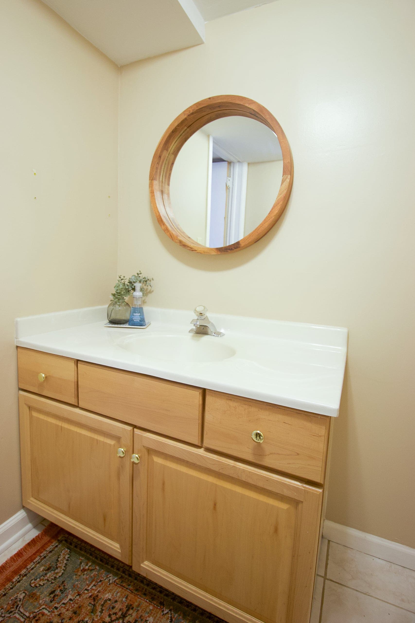 Round wood mirror in our bathroom