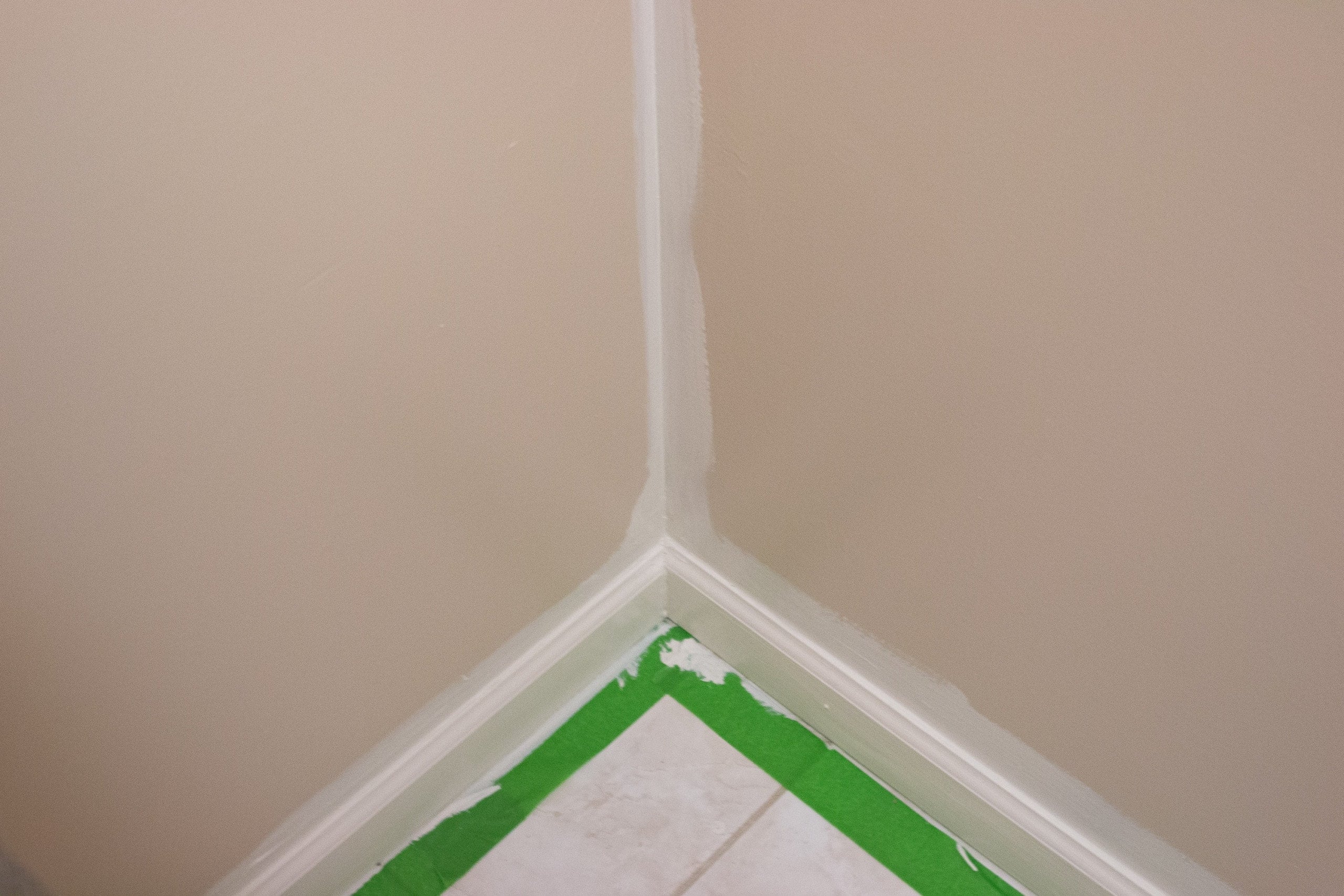 Cutting in the corners of a bathroom with a brush