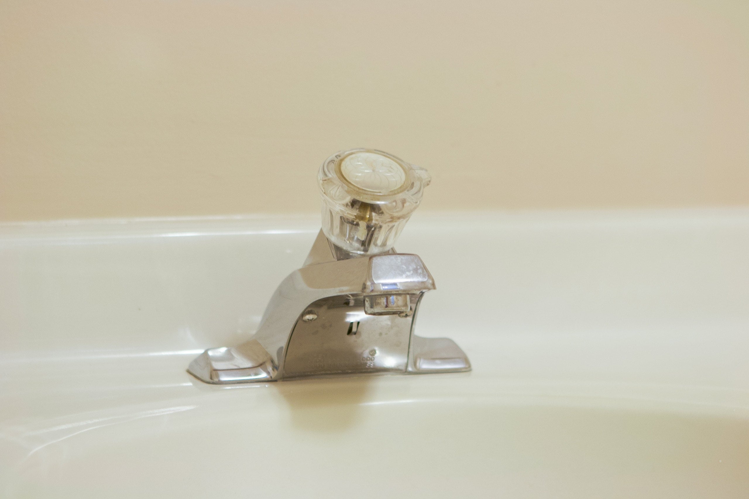 outdated faucet in our basement bathroom