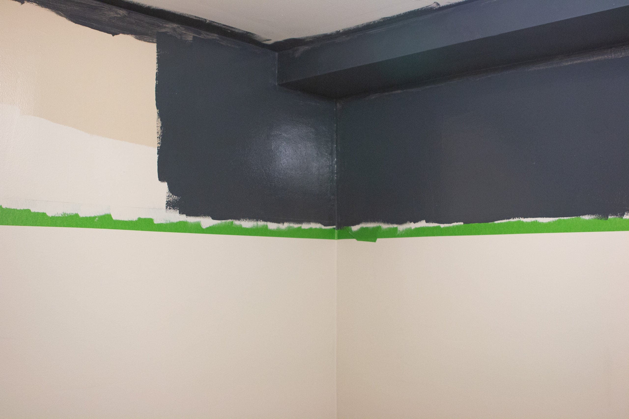 Painting the top portion of the two-tone walls the color Chimney Smoke by Valspar