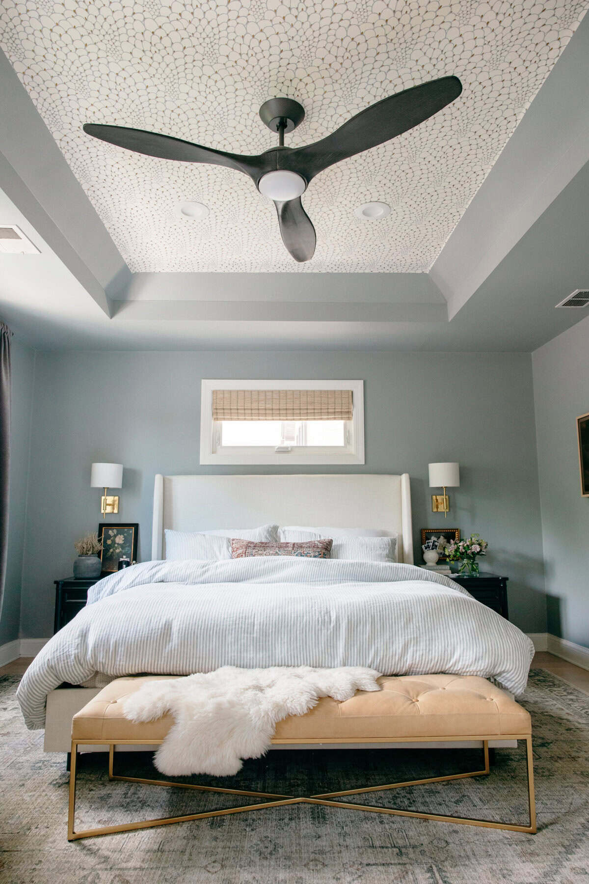 Neutral sand 9x12 rug anchoring king bed with layered bedding